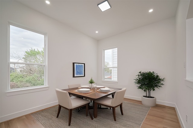 dining room featuring plenty of natural light, recessed lighting, light wood-style floors, and baseboards