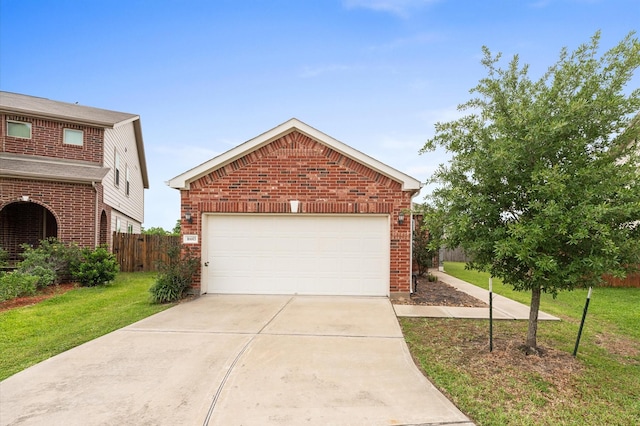traditional-style home featuring fence, a front lawn, brick siding, a garage, and driveway