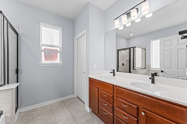 bathroom featuring a sink, baseboards, a shower stall, and double vanity