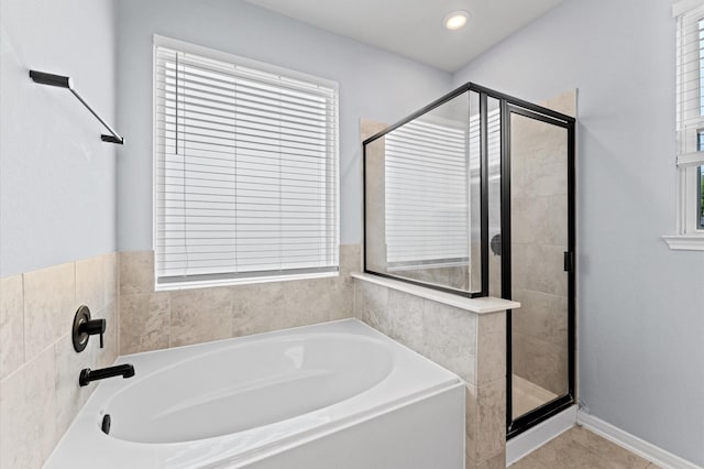 bathroom featuring a shower stall and a wealth of natural light