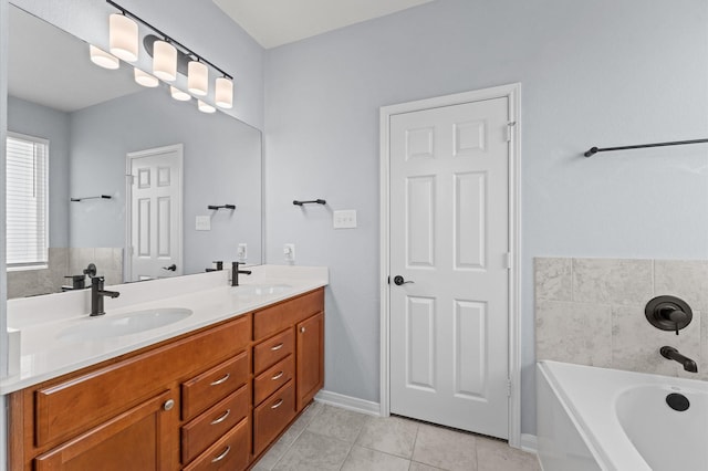 full bath with double vanity, tile patterned floors, a sink, and a bath