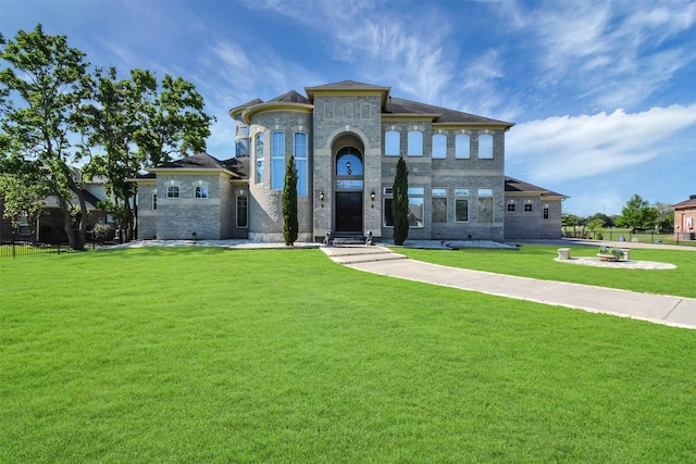 view of front of property with fence, a front lawn, and brick siding