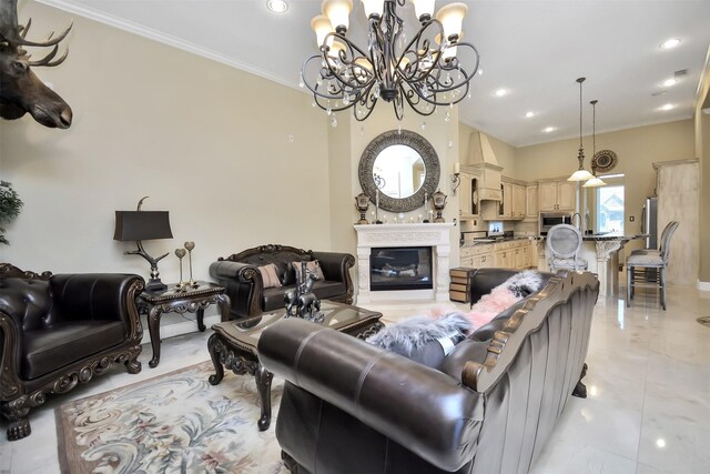living area with crown molding, a glass covered fireplace, recessed lighting, and a notable chandelier