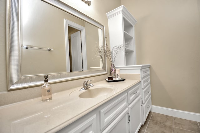 bathroom featuring vanity, baseboards, and tile patterned floors