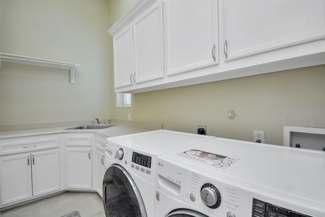 laundry room with a sink, light tile patterned floors, independent washer and dryer, and cabinet space