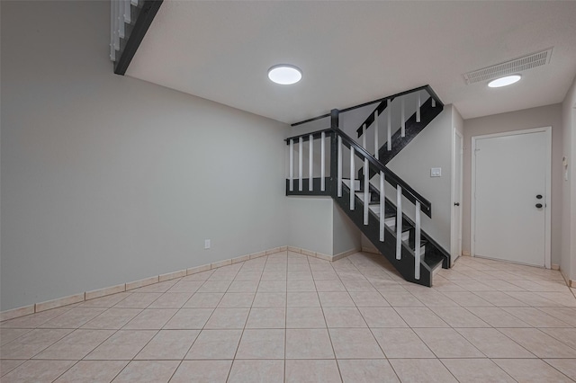 stairway featuring visible vents and tile patterned flooring