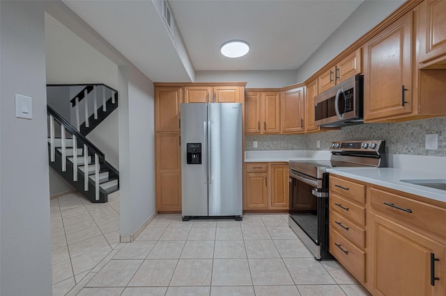 kitchen featuring light countertops, stainless steel appliances, visible vents, and light tile patterned floors