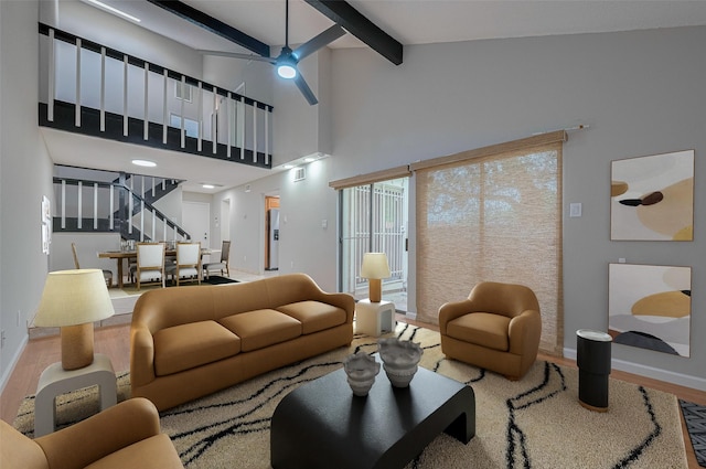 3224 Windchase Blvd Unit 495, Houston, TX 77082 - living area featuring beamed ceiling, baseboards, wood finished floors, stairs, and a ceiling fan