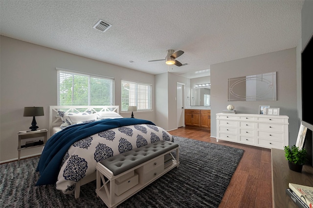 3224 Windchase Blvd Unit 495, Houston, TX 77082 - bedroom with wood finished floors, a textured ceiling, ensuite bath, and a ceiling fan
