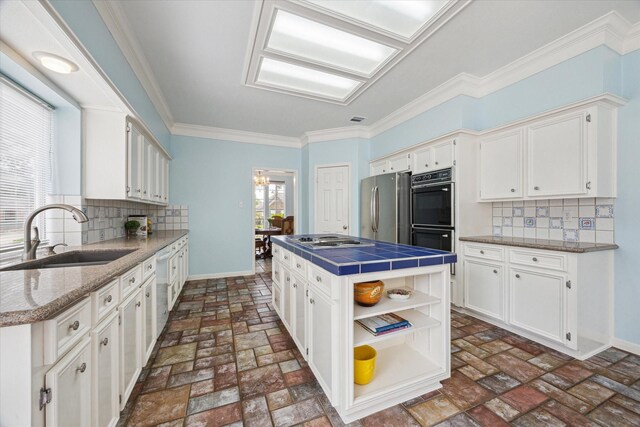 4107 Pebble Beach Dr, League City, TX 77573 - kitchen with a sink, appliances with stainless steel finishes, white cabinetry, baseboards, and ornamental molding