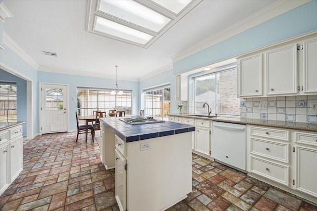 4107 Pebble Beach Dr, League City, TX 77573 - kitchen featuring dishwasher, tile counters, a sink, brick floors, and backsplash