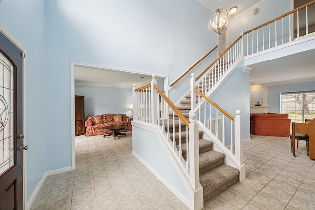 4107 Pebble Beach Dr, League City, TX 77573 - foyer with a high ceiling, ornamental molding, a chandelier, stairs, and baseboards