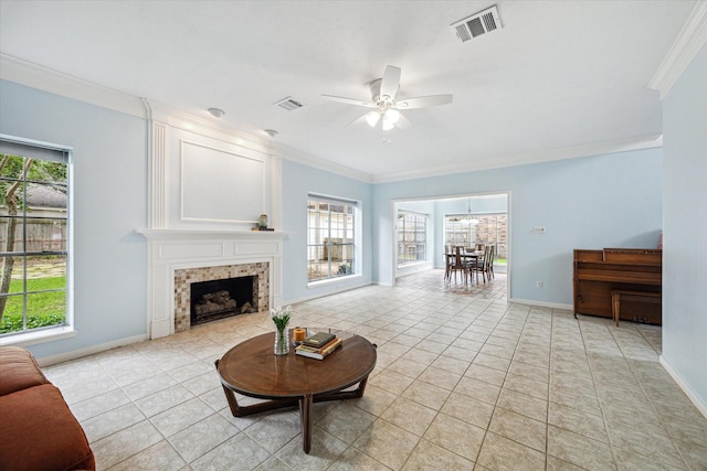 4107 Pebble Beach Dr, League City, TX 77573 - living area with ornamental molding, ceiling fan, light tile patterned floors, baseboards, and a tiled fireplace