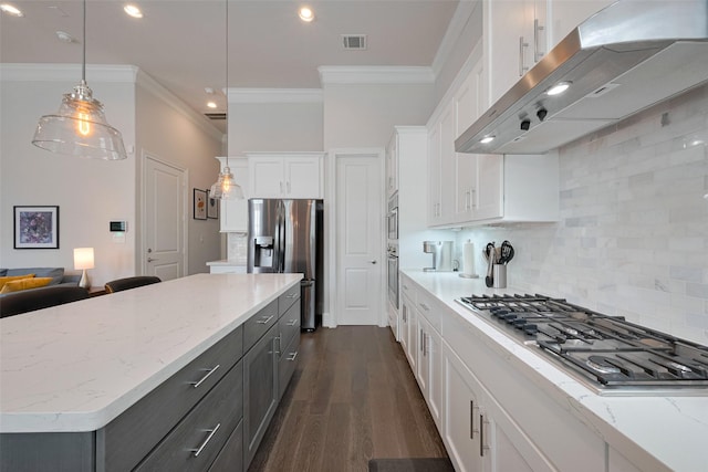 kitchen with appliances with stainless steel finishes, white cabinetry, range hood, tasteful backsplash, and ornamental molding