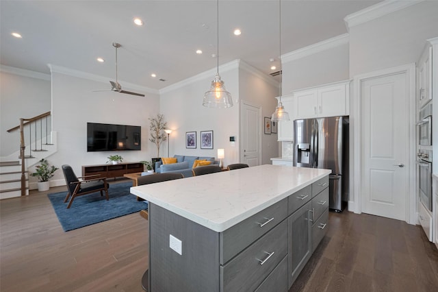 kitchen featuring crown molding, a center island, white cabinets, gray cabinetry, and stainless steel appliances