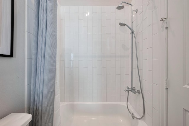 bathroom with shower / bath combo with shower curtain and toilet
