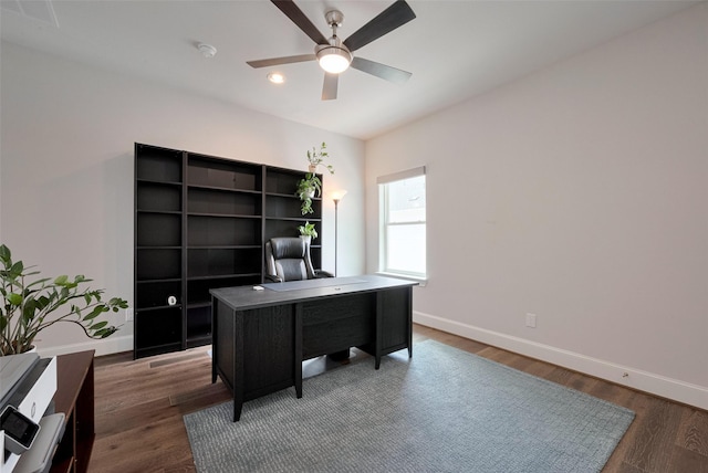 office area with baseboards, ceiling fan, and wood finished floors