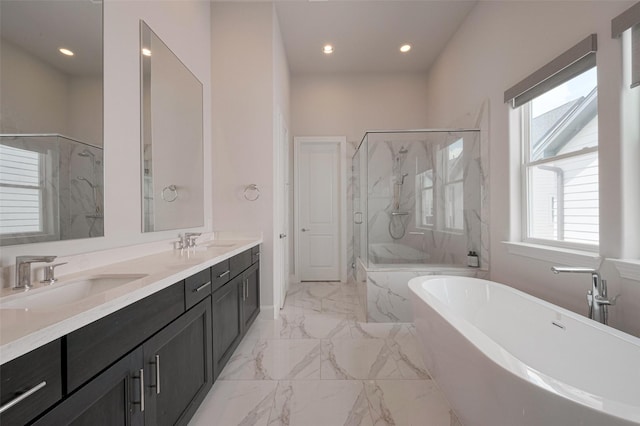 full bath with a sink, a marble finish shower, marble finish floor, and a freestanding tub