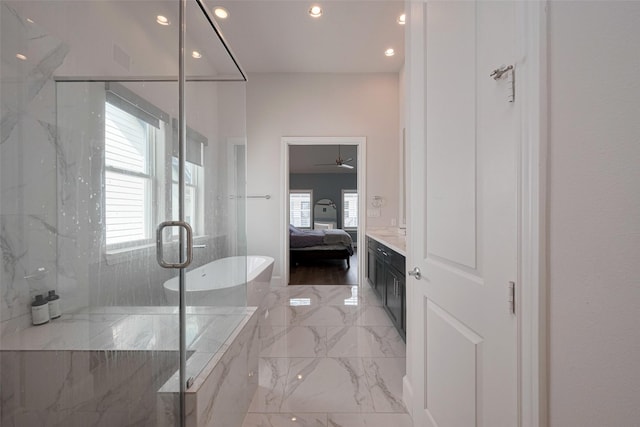 bathroom featuring marble finish floor, recessed lighting, a ceiling fan, a marble finish shower, and ensuite bath