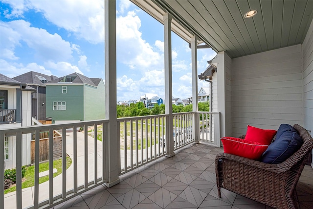sunroom / solarium featuring a residential view