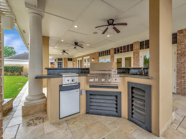 view of patio featuring beverage cooler, a ceiling fan, grilling area, and an outdoor kitchen