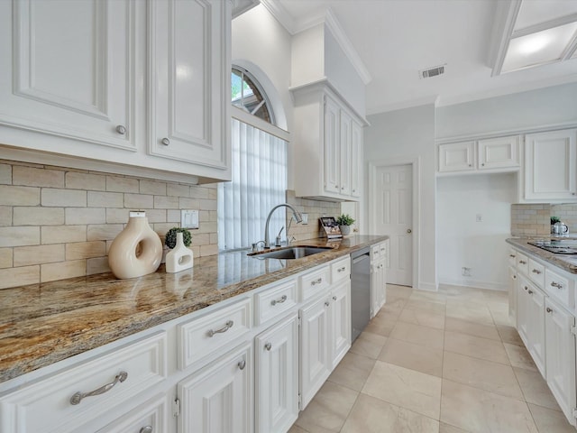 kitchen featuring decorative backsplash, visible vents, stainless steel dishwasher, light stone countertops, and a sink