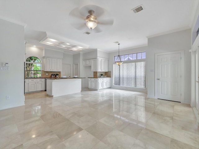 unfurnished living room featuring baseboards, ornamental molding, ceiling fan, and visible vents