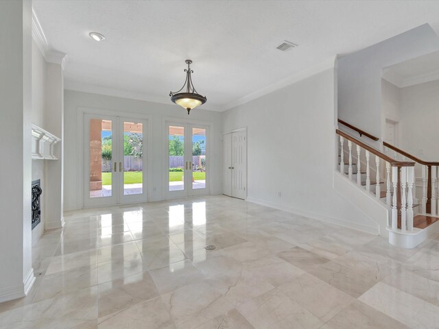 unfurnished living room featuring stairway, ornamental molding, french doors, and visible vents