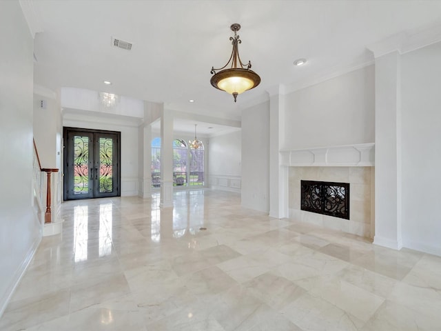 unfurnished living room with crown molding, visible vents, marble finish floor, and a decorative wall