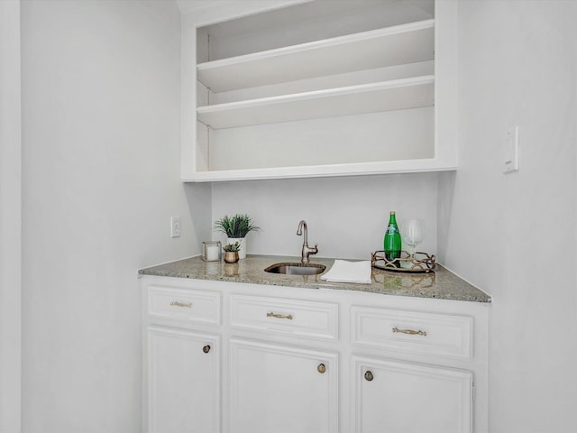 bar featuring indoor wet bar and a sink
