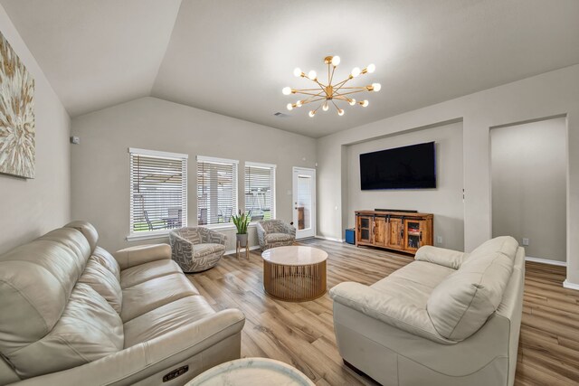 11430 Raven Claw Dr, Tomball, TX 77375 - living room featuring a chandelier, lofted ceiling, light wood finished floors, and baseboards