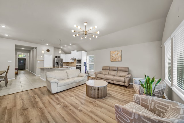 11430 Raven Claw Dr, Tomball, TX 77375 - living room with vaulted ceiling, light wood-style floors, a chandelier, baseboards, and recessed lighting