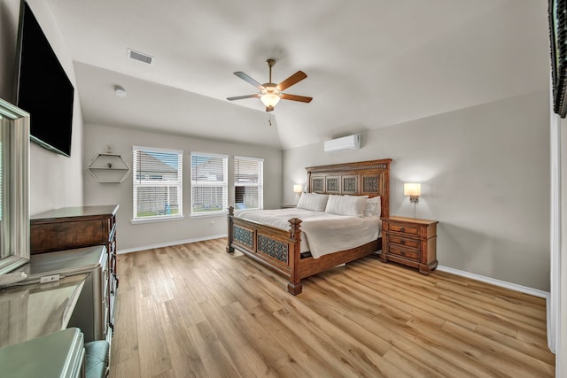 11430 Raven Claw Dr, Tomball, TX 77375 - bedroom with an AC wall unit, light wood finished floors, baseboards, and vaulted ceiling