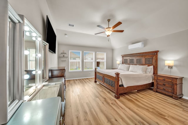 11430 Raven Claw Dr, Tomball, TX 77375 - bedroom with a wall mounted air conditioner, light wood-style flooring, baseboards, lofted ceiling, and ceiling fan