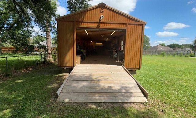 view of outbuilding with fence and an outbuilding