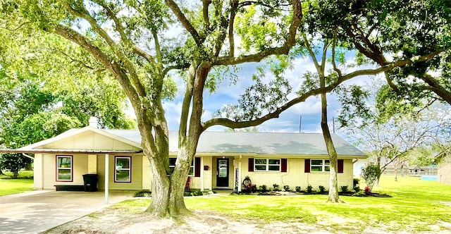 ranch-style house featuring a carport, concrete driveway, a front lawn, and brick siding