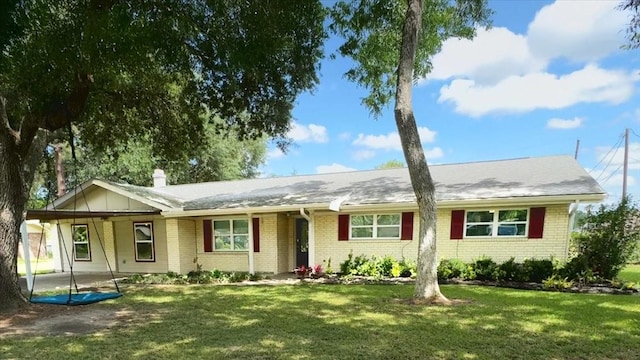 ranch-style house with brick siding, a front lawn, and a chimney