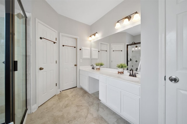 bathroom with double vanity, a sink, and a stall shower