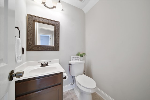 half bath with vanity, baseboards, toilet, and tile patterned flooring