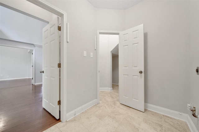 hall featuring baseboards