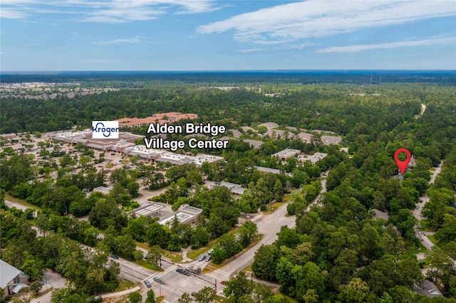 bird's eye view with a wooded view