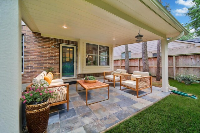 view of patio featuring fence and an outdoor hangout area