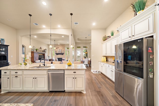 13105 Parc Cove Ct, Cypress, TX 77429 - kitchen featuring stainless steel appliances, a sink, open floor plan, dark wood-style flooring, and tasteful backsplash