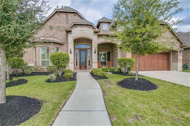 13105 Parc Cove Ct, Cypress, TX 77429 - french country inspired facade featuring brick siding, concrete driveway, a front lawn, and a garage