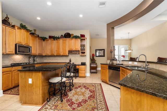 2010 Cias Trail Ln, Spring, TX 77386 - kitchen with appliances with stainless steel finishes, a sink, decorative backsplash, light tile patterned floors, and visible vents
