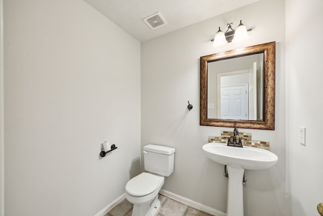 23026 Eastgate Village Dr, Spring, TX 77373 - half bathroom with visible vents, baseboards, tile patterned flooring, and toilet