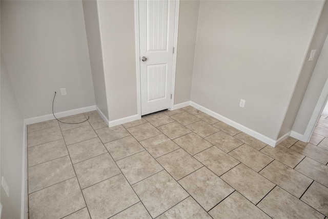 unfurnished bedroom with baseboards and light tile patterned flooring