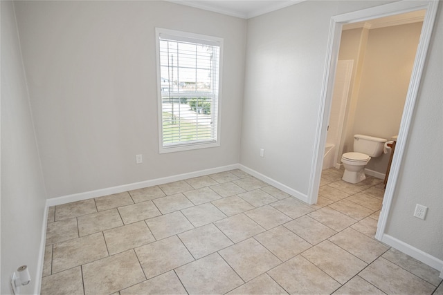 interior space featuring crown molding, baseboards, ensuite bathroom, and light tile patterned flooring