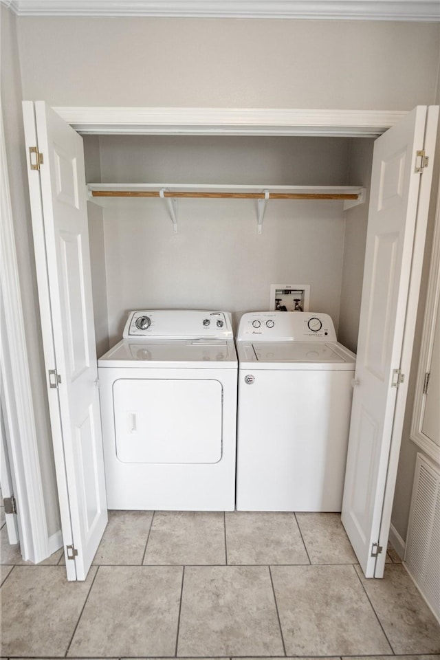 washroom with light tile patterned floors, laundry area, visible vents, and washer and clothes dryer