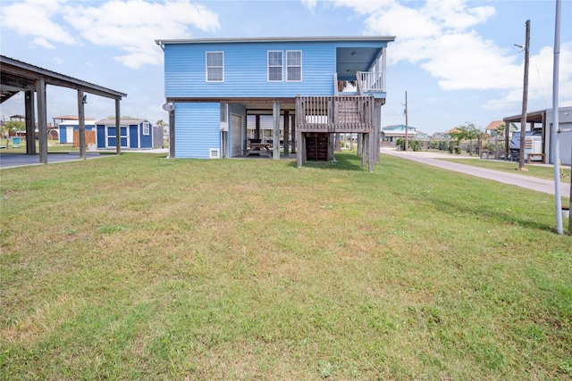 rear view of house with a yard and stairs